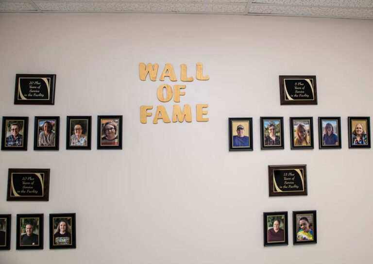 A wall featuring 'Wall of Fame' with resident photos