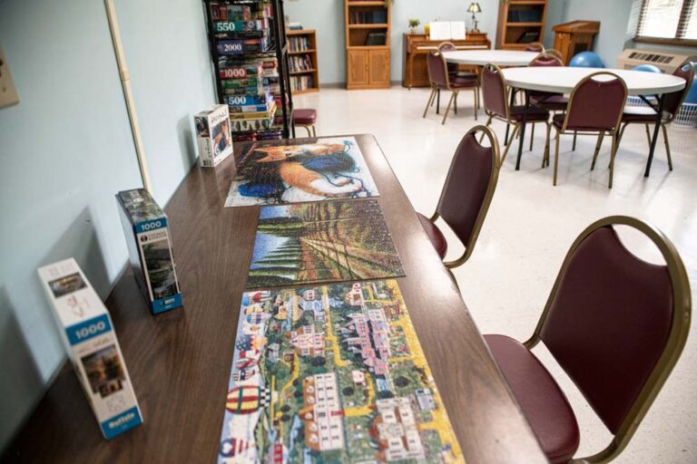 Common area with puzzle tables in a recreational room