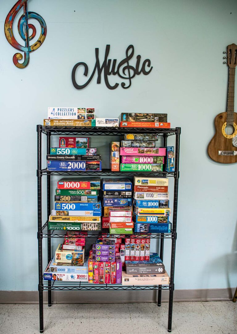 Puzzle collection on a shelf in a common area