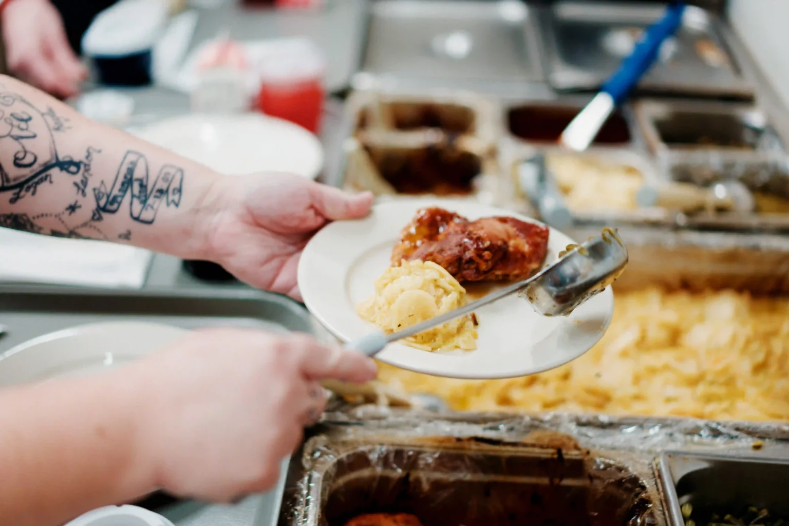 A staff member serving food in the dining room