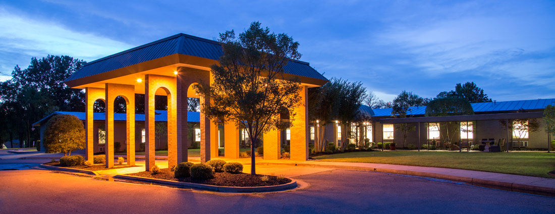 Exterior view of a senior living facility at dusk