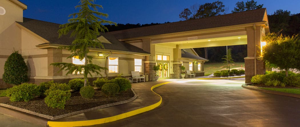 Well-lit entrance of a nursing home facility at night
