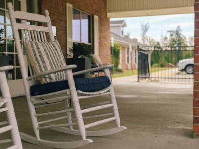 Rocking chairs on a porch at a senior facility