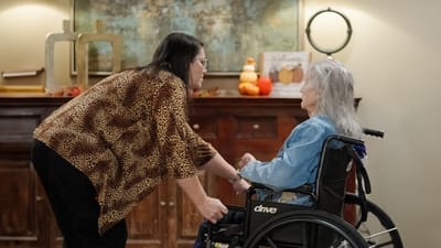 Staff interacting with a resident in a cozy common area