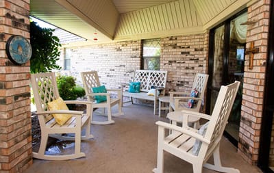 Outdoor seating area with rocking chairs and cushions