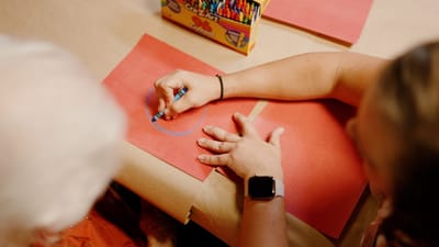 Engaging activity with elderly resident using crayons