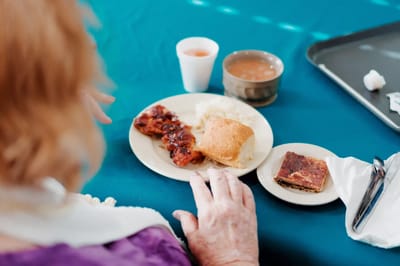 Resident enjoying a meal in the dining room