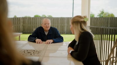 Residents engaging in conversation at an outdoor table