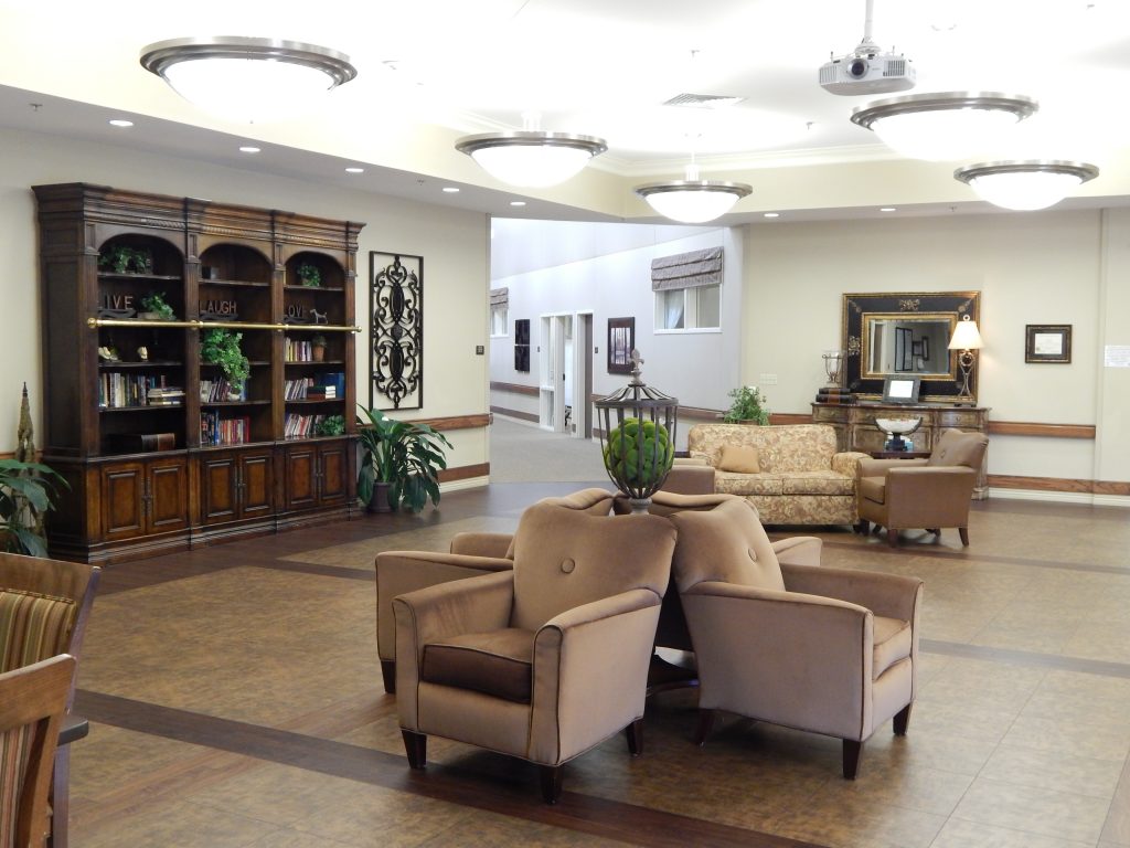 A cozy common area with seating and bookshelves