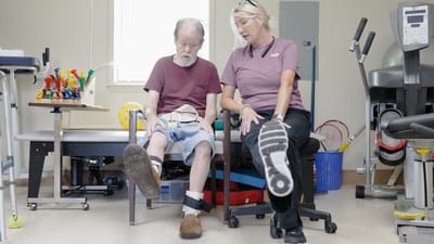 Therapist assisting a resident with foot exercises