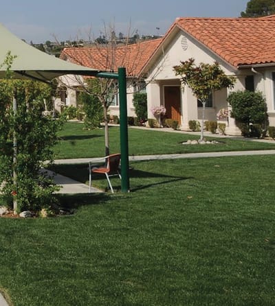 Well-maintained garden area with seating in a senior living facility