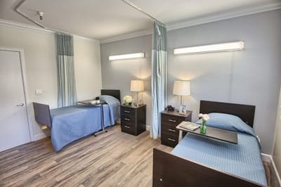 Interior view of a shared living space with two beds