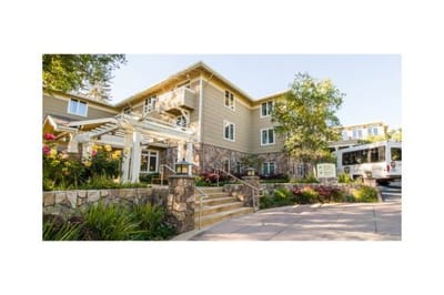 Entrance of a senior living facility with landscaped gardens