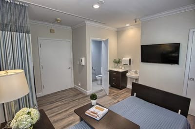 A well-furnished private room in a nursing home