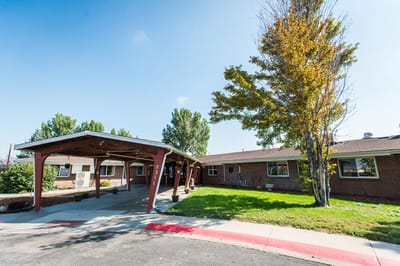 Exterior view of a senior living facility with trees