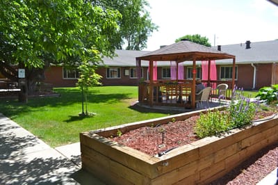 Outdoor seating area with gazebo and resident relaxing
