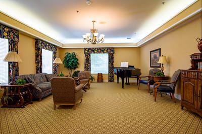 A cozy common area with seating and a piano