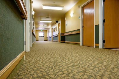 Well-lit hallway in a senior living facility