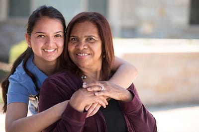 A caregiver and resident sharing a joyful moment