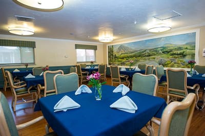 Dining area with tables and a mural on the wall