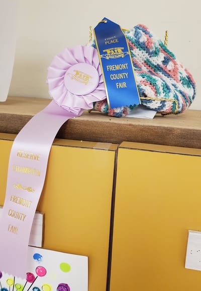 Progressive Care Center, Nursing Home in Shreveport, LA — Award ribbons displayed alongside a handmade knitted item