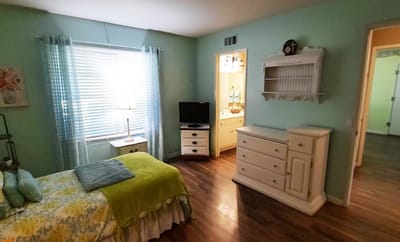 Well-lit resident room with furniture and decor