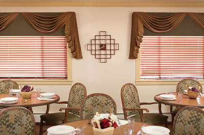 Dining room setup with tables and floral decorations