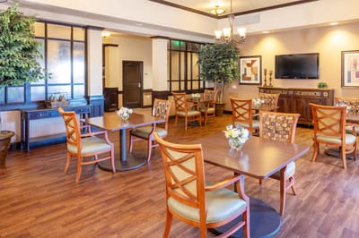 Bright common area with dining tables and seating