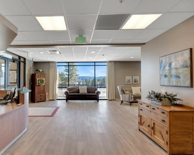 Bright common area with seating and large windows
