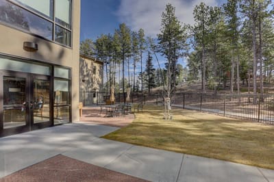 Outdoor seating area next to a modern facility