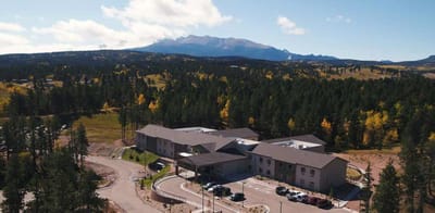 Aerial view of a senior living facility surrounded by mountains