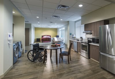 A modern assisted living kitchen and lounge area