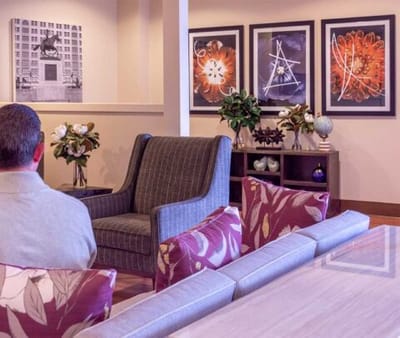 Resident sitting in a cozy common area with artwork
