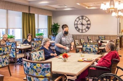Residents enjoying a meal in a dining area.