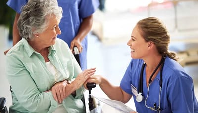 Wellington Manor Knoxville, nursing home in Knoxville, TN — Nurse interacting with a smiling senior resident