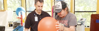 Therapist assisting resident with an exercise ball