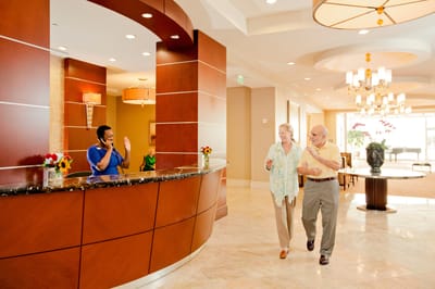 Residents engaging with staff in a reception area