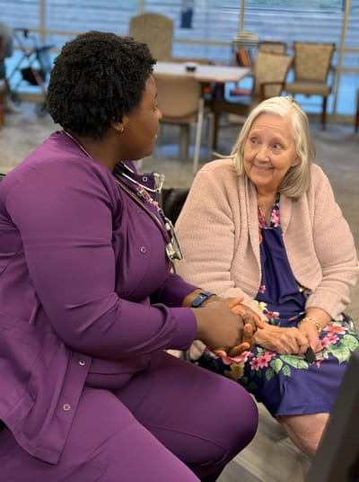 Staff member engaging with a resident in a common area