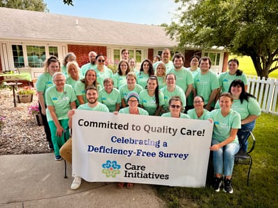 Staff and residents celebrating in the outdoor space