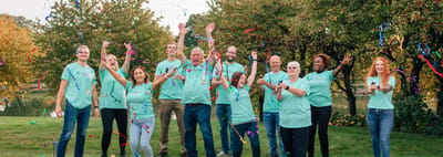 Staff celebrating outdoors with confetti