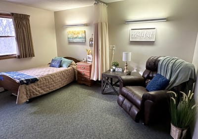 Cozy resident room with a bed and recliner
