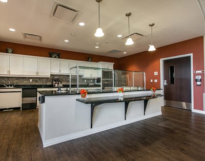 Bright dining area with a serving counter and flowers