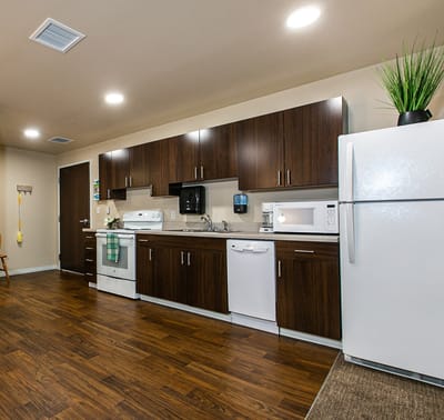 Modern kitchen area with appliances and cabinets