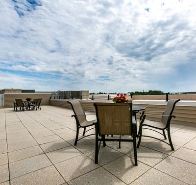 Outdoor patio with chairs and flower pots