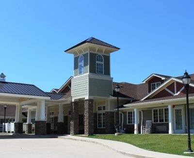 Exterior view of a senior living facility with gardens