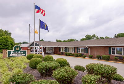 Exterior of Parkview Care Center with flags and landscaping