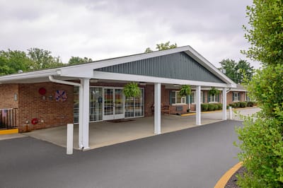 Front entrance of a senior living facility with awning