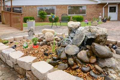 A peaceful outdoor space with a fountain and seating