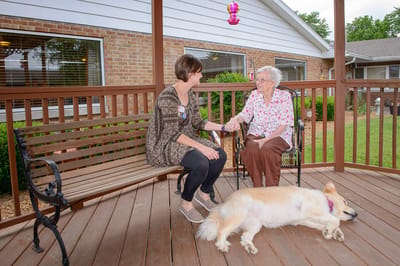 An elderly woman and staff member enjoying the outdoors