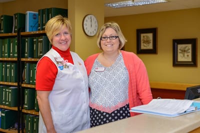 Staff members smiling at the reception area